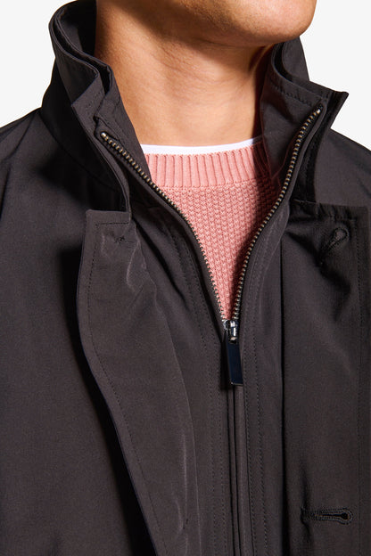 Men's black stand collar jacket with zip front and button details