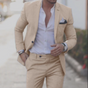 Men's textured two piece suit with notched lapel blazer and tapered trousers