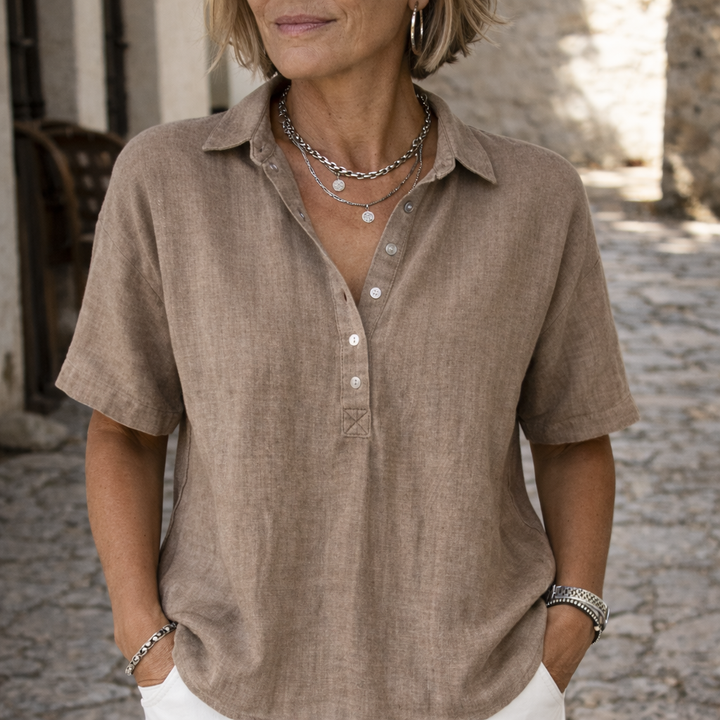 Women's short sleeve collared button blouse with polo neckline