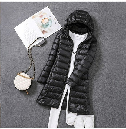 Women's hooded longline puffer coat with quilted panels and zip front