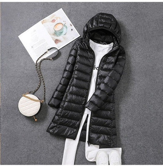 Women's hooded longline puffer coat with quilted panels and zip front