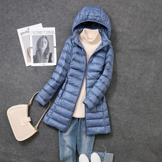 Women's hooded longline puffer coat with quilted panels and zip front