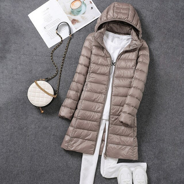 Women's hooded longline puffer coat with quilted panels and zip front
