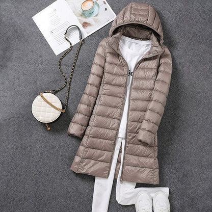 Women's hooded longline puffer coat with quilted panels and zip front