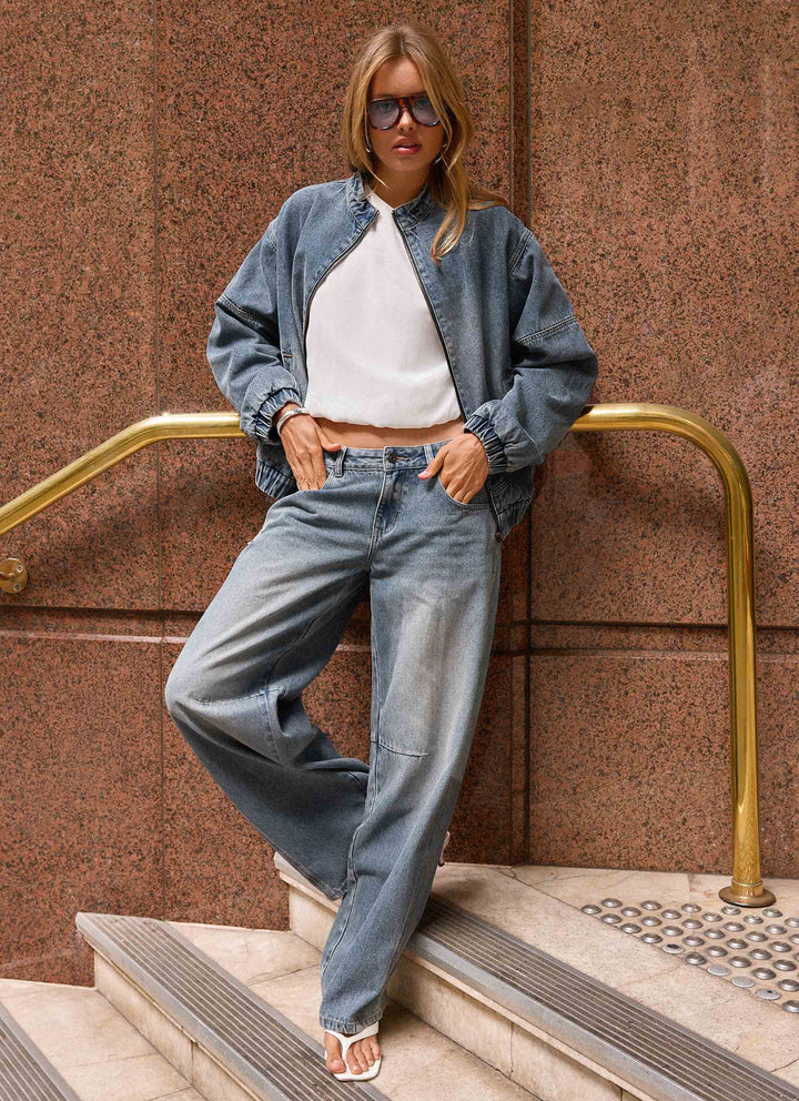 Women's blue denim bomber jacket with stand collar and cropped fit