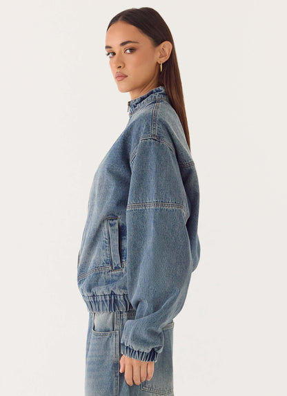 Women's blue denim bomber jacket with stand collar and cropped fit