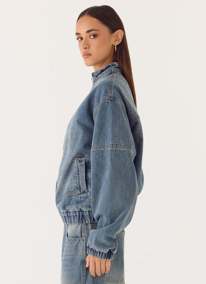 Women's blue denim bomber jacket with stand collar and cropped fit