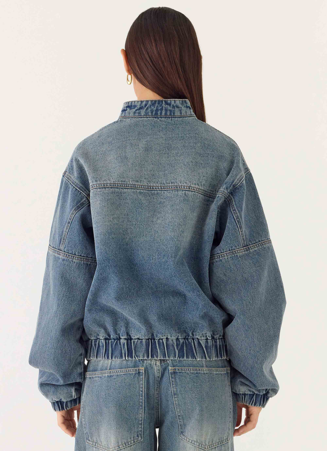 Women's blue denim bomber jacket with stand collar and cropped fit