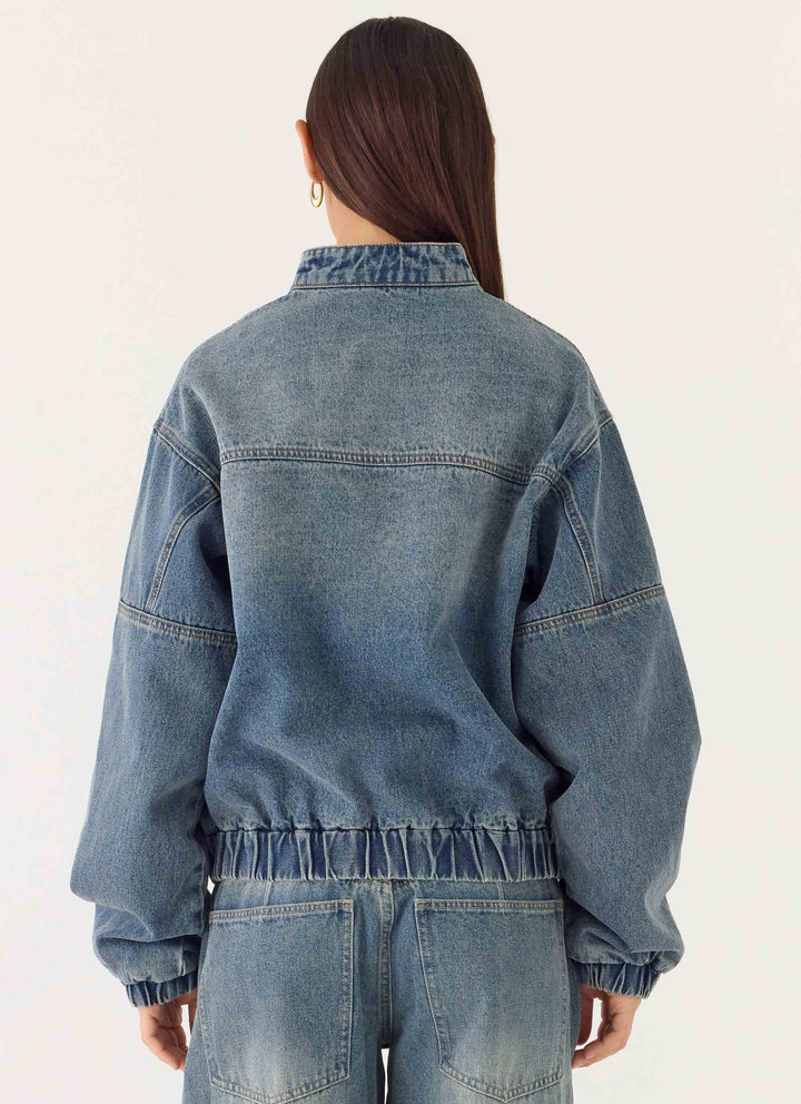 Women's blue denim bomber jacket with stand collar and cropped fit