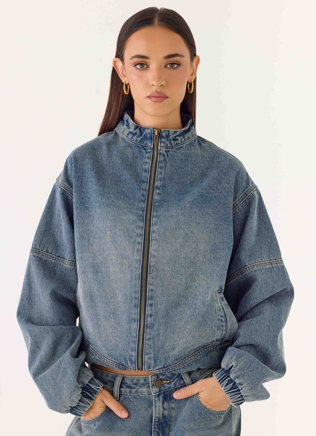 Women's blue denim bomber jacket with stand collar and cropped fit