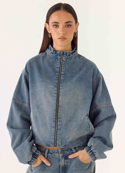 Women's blue denim bomber jacket with stand collar and cropped fit
