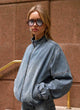 Women's blue denim bomber jacket with stand collar and cropped fit