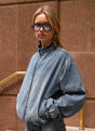 Women's blue denim bomber jacket with stand collar and cropped fit