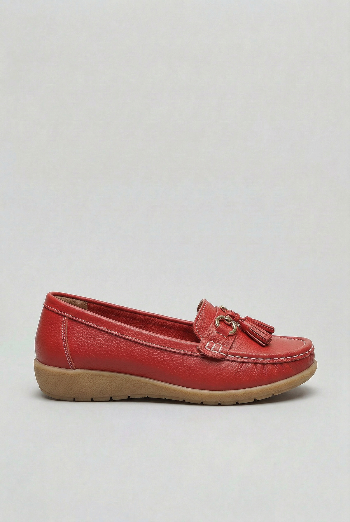 Women's slip-on tassel loafer with metal bit detail and low wedge sole