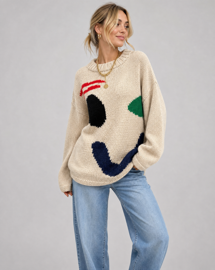 Women's oversized knit sweater with a large smiley face graphic