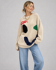 Women's oversized knit sweater with a large smiley face graphic