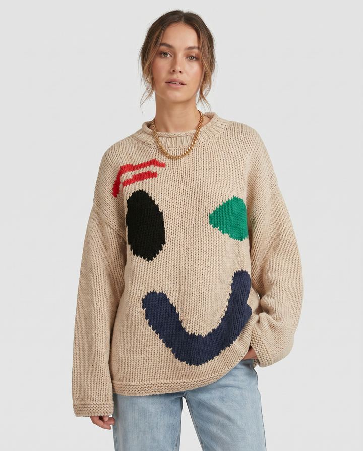 Women's oversized knit sweater with a large smiley face graphic