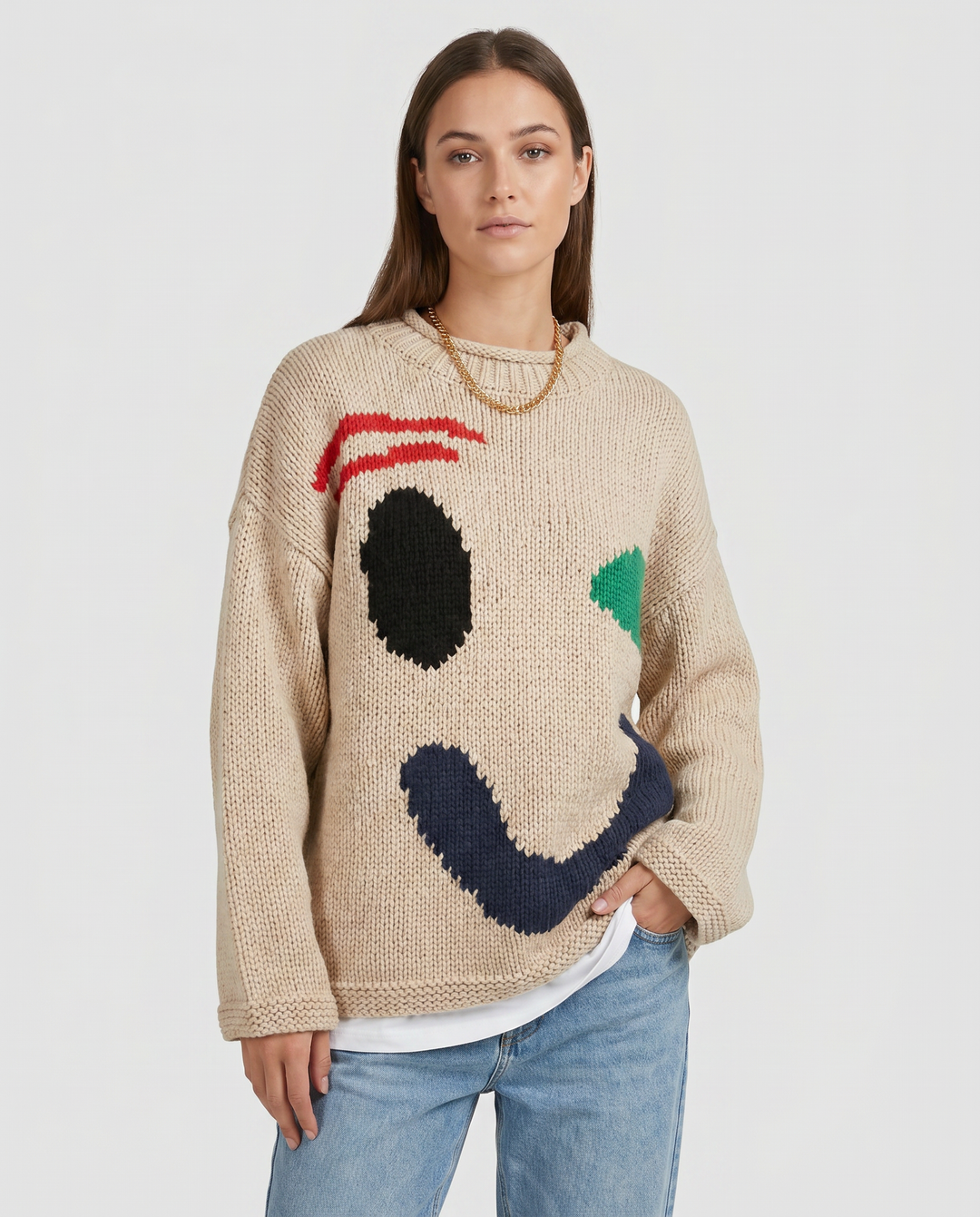 Women's oversized knit sweater with a large smiley face graphic
