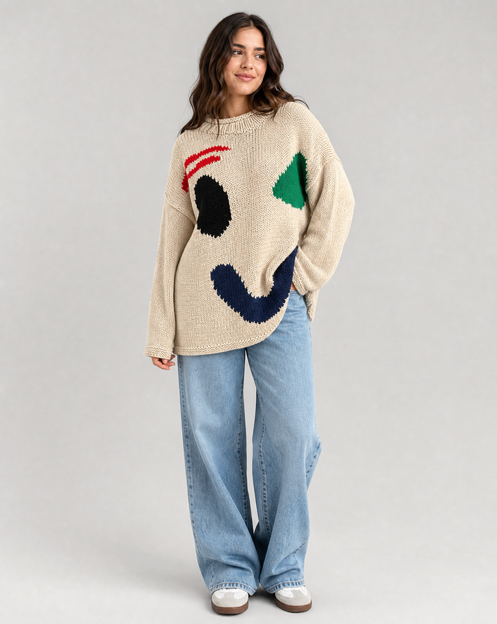Women's oversized knit sweater with a large smiley face graphic