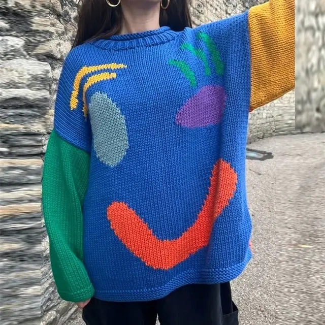 Women's oversized knit sweater with a large smiley face graphic