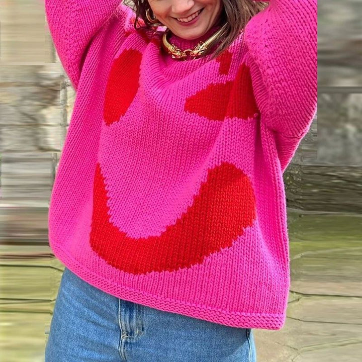 Women's oversized knit sweater with a large smiley face graphic