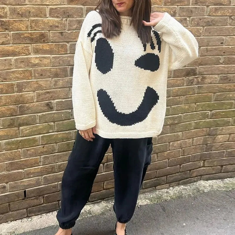 Women's oversized knit sweater with a large smiley face graphic