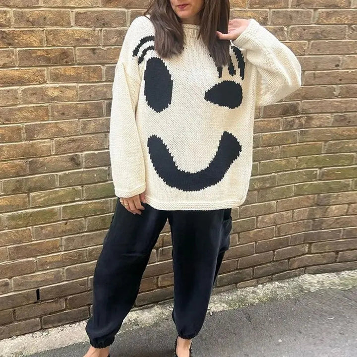 Women's oversized knit sweater with a large smiley face graphic