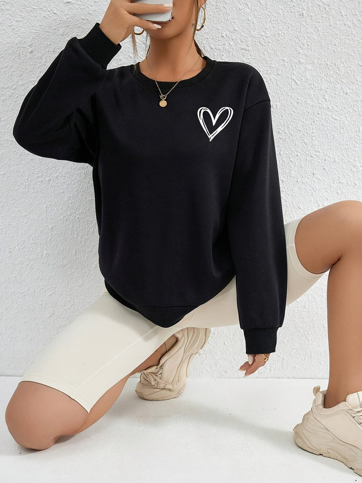 Women's crew neck sweatshirt with long sleeves and heart chest graphic