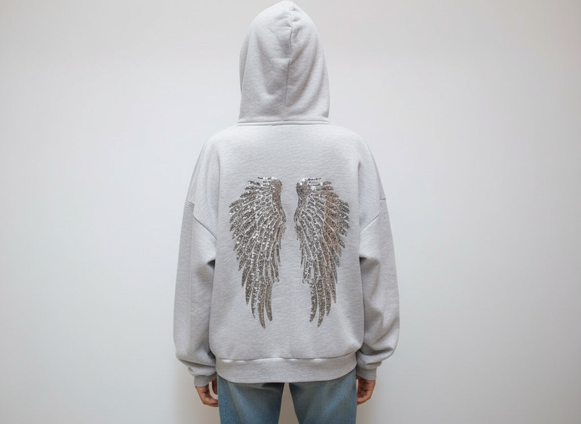 Women's gray hoodie with drawstring hood and silver sequin wings on the back