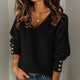 Women's ribbed V-neck sweater with long sleeves and button cuff details