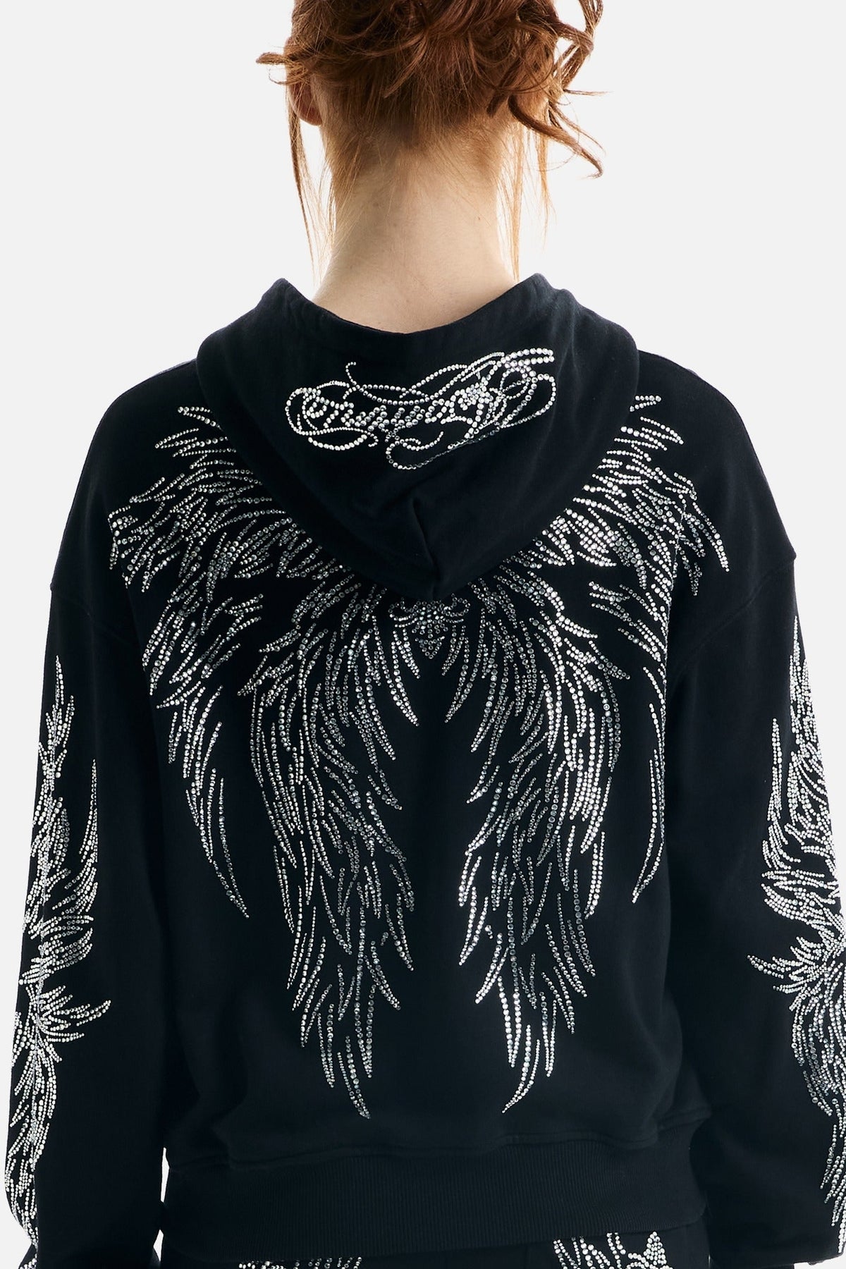 Women's black zip-up hoodie with silver rhinestone wing designs