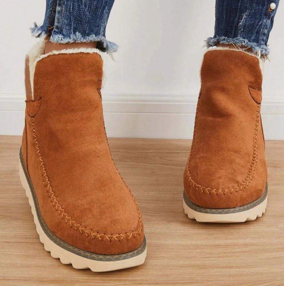 Women's short lined slip-on ankle boots with round toes, contrast trim and ridged platform soles