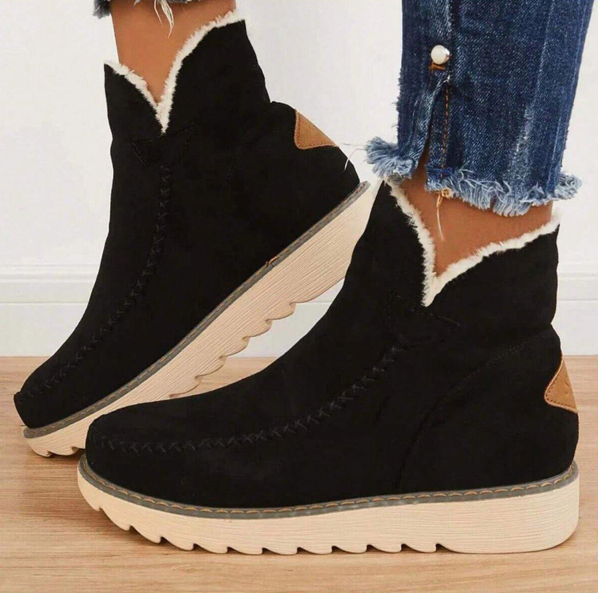 Women's short lined slip-on ankle boots with round toes, contrast trim and ridged platform soles