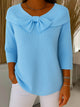 Women's ribbed sweater top with boat neckline and front bow