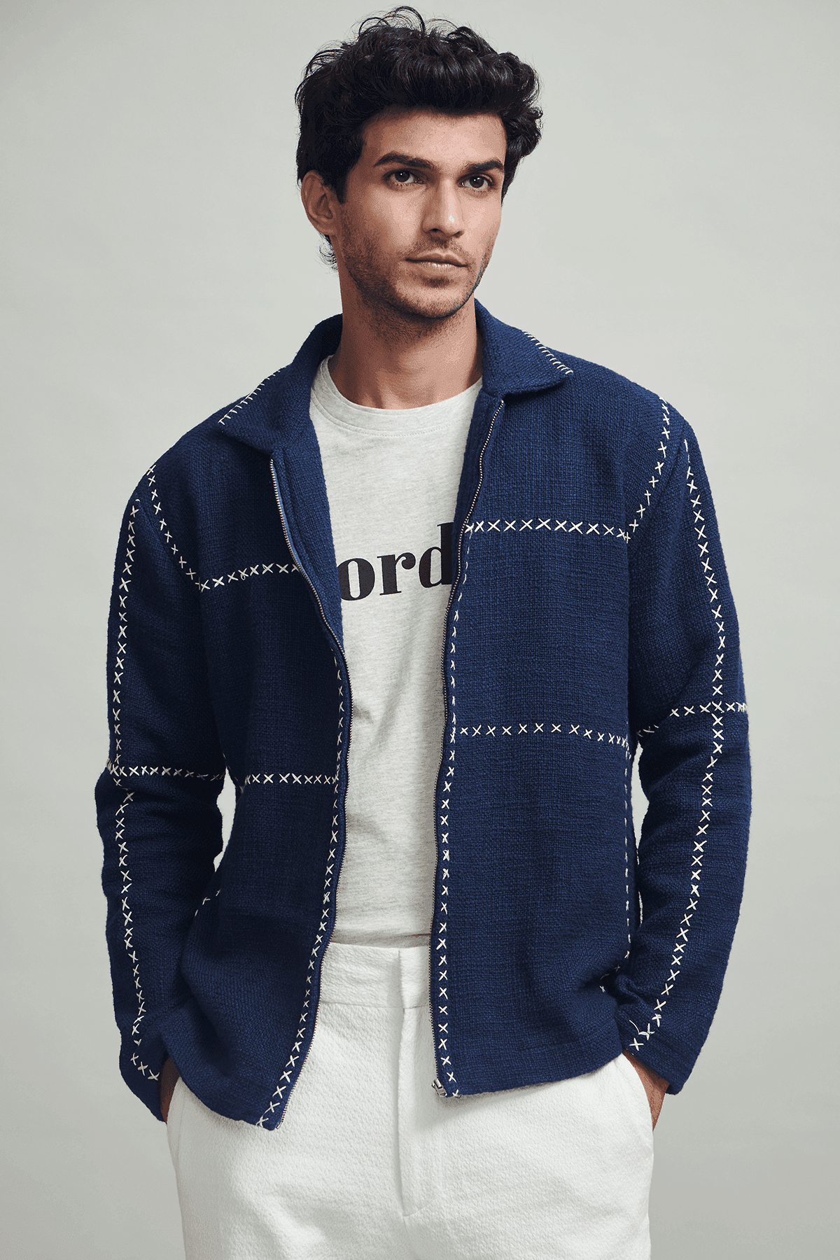 Men's navy zip jacket with stand collar and contrasting cross-stitch detailing