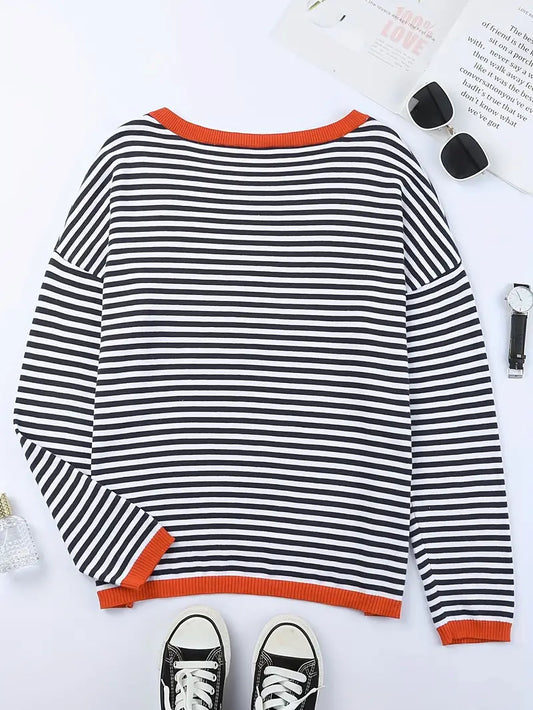 Women's black and white striped jumper with orange ribbed trim