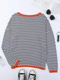 Women's black and white striped jumper with orange ribbed trim