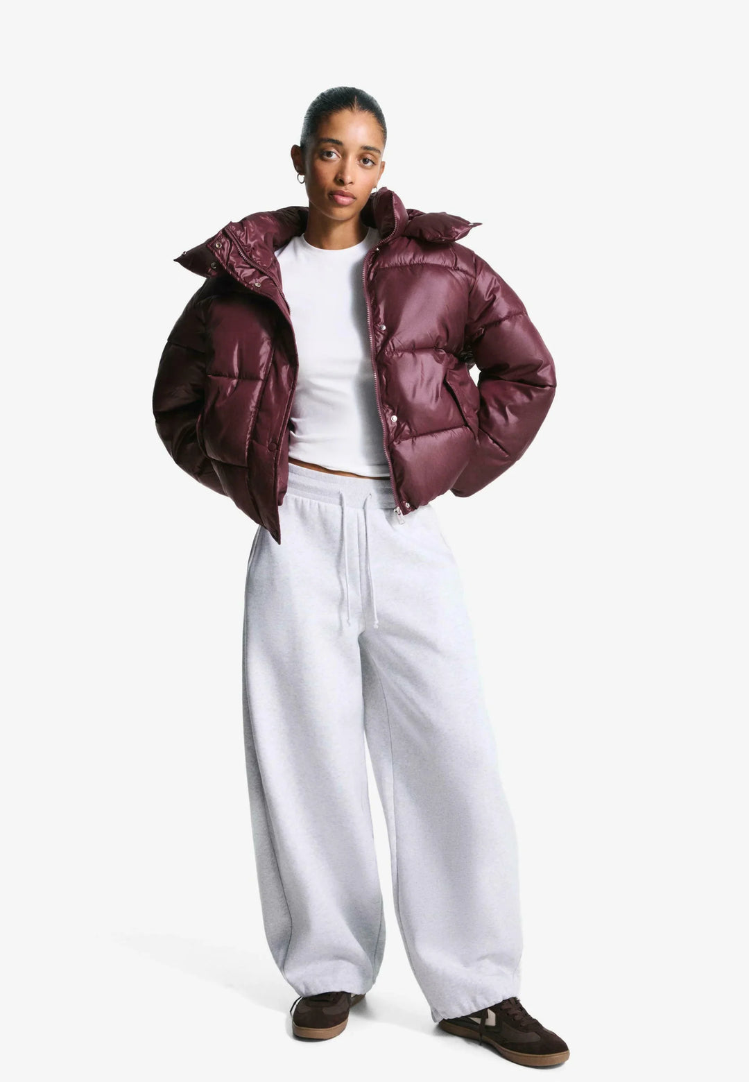 Women's burgundy quilted hooded puffer jacket with snap front and front pockets