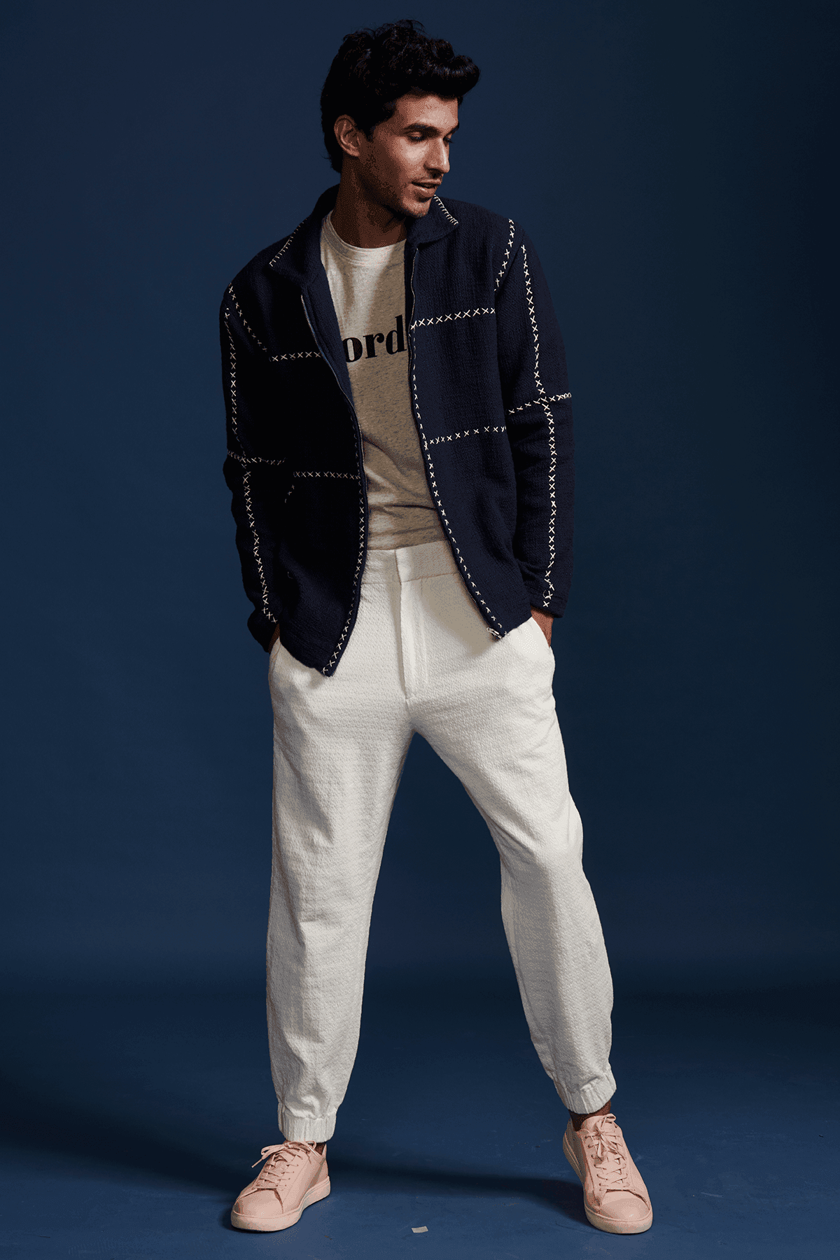 Men's navy zip jacket with stand collar and contrasting cross-stitch detailing