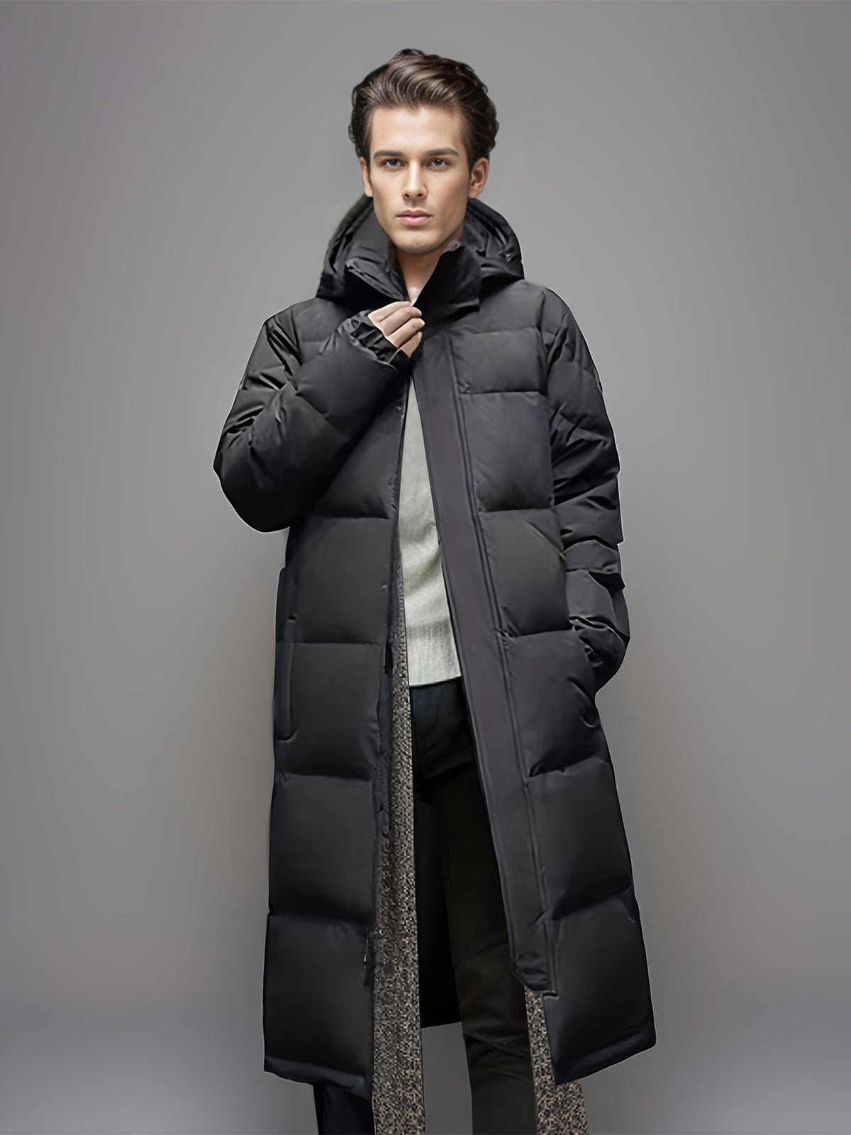Men's black long hooded puffer coat with quilted panels and zip front