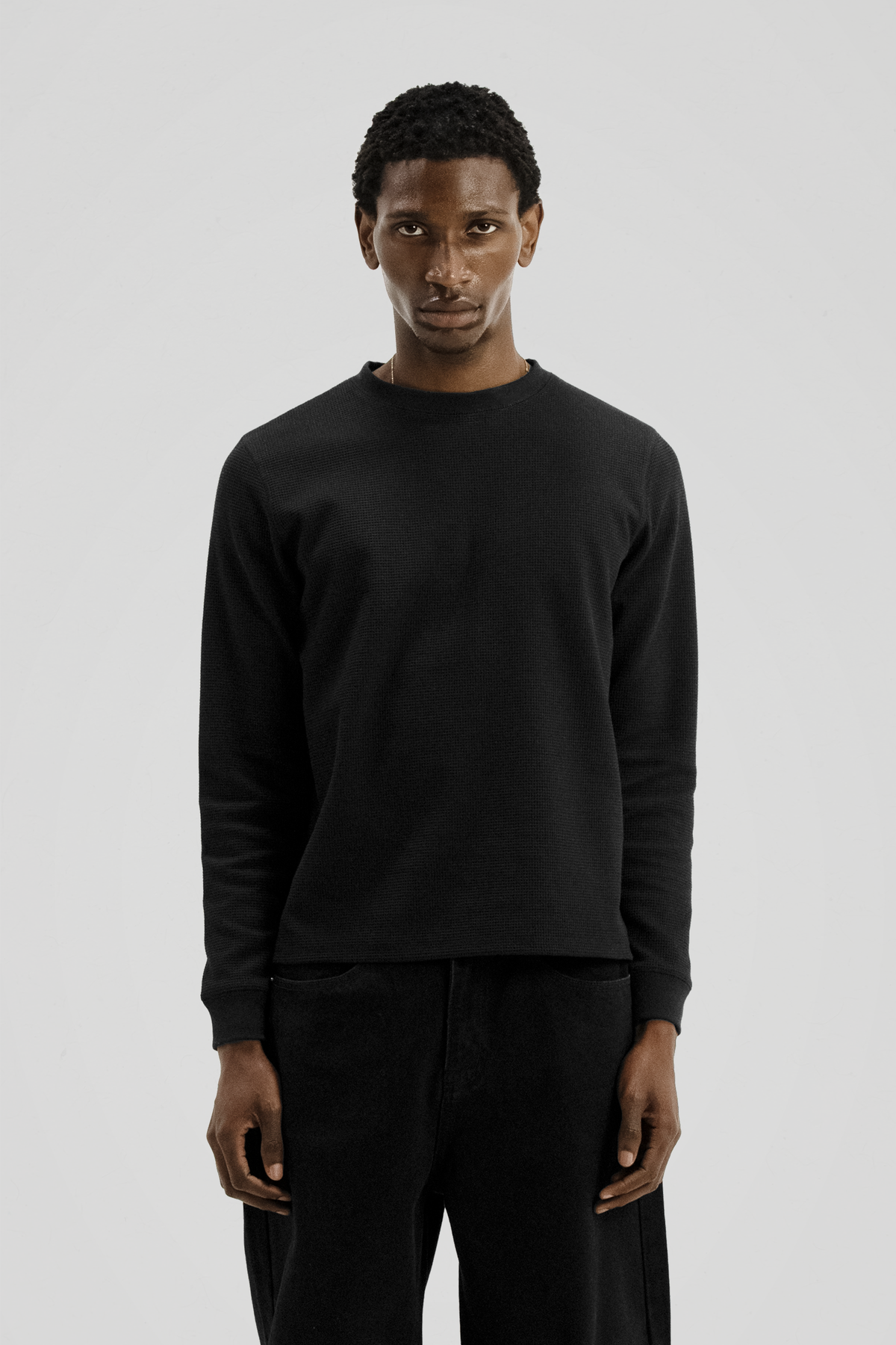Men's black long sleeve crew neck top with textured finish