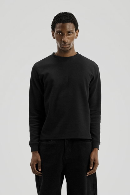 Men's black long sleeve crew neck top with textured finish