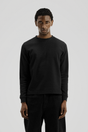 Men's black long sleeve crew neck top with textured finish
