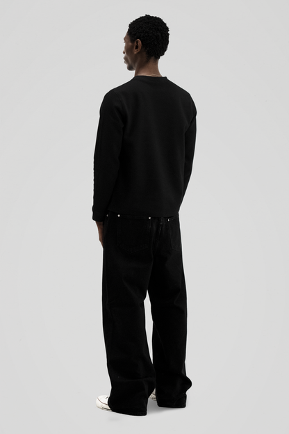 Men's black long sleeve crew neck top with textured finish