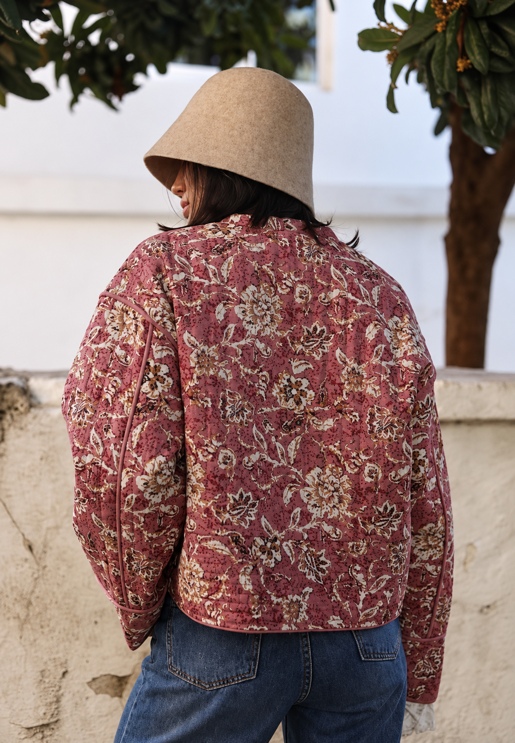 Women's pink floral quilted jacket with button front and piped trims