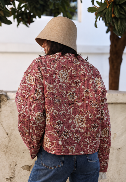 Women's pink floral quilted jacket with button front and piped trims