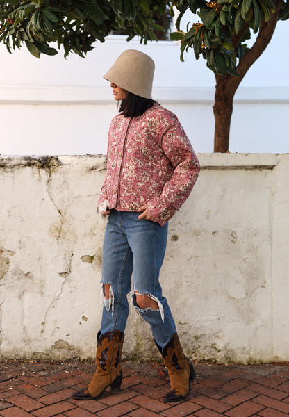 Women's pink floral quilted jacket with button front and piped trims