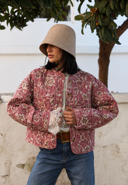 Women's pink floral quilted jacket with button front and piped trims