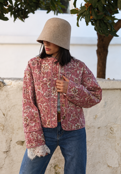 Women's pink floral quilted jacket with button front and piped trims