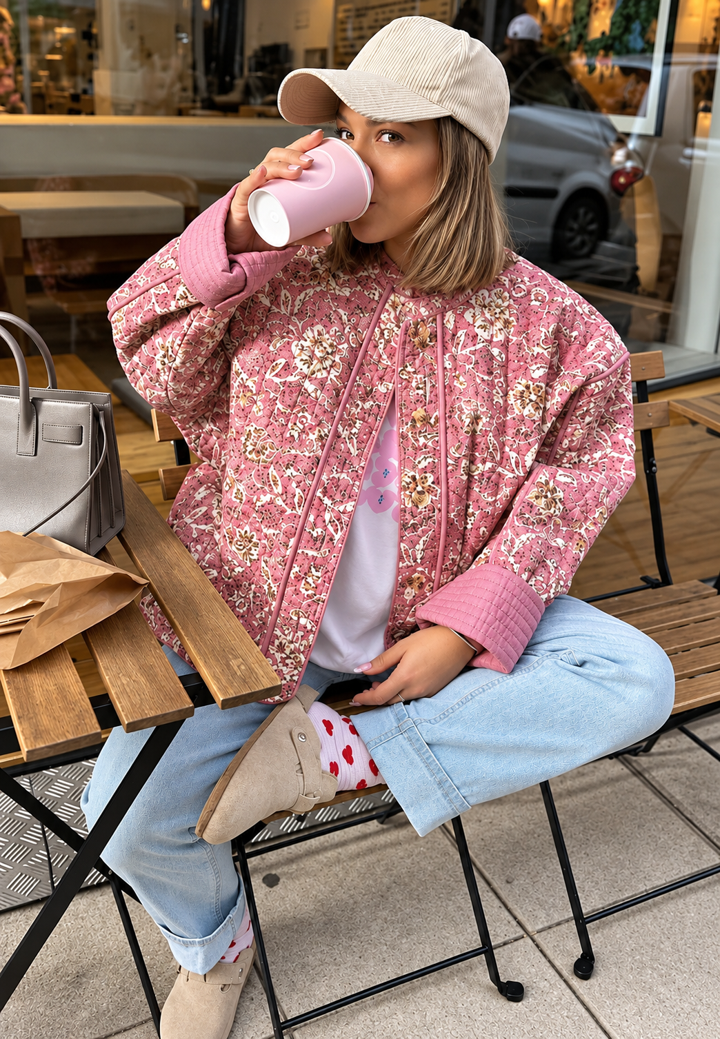 Women's pink floral quilted jacket with button front and piped trims